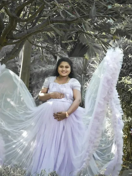 A creative solo portrait using a black and white effect on the background to make the subject and her flowing lavender gown stand out. This technique adds an artistic and dramatic flair.