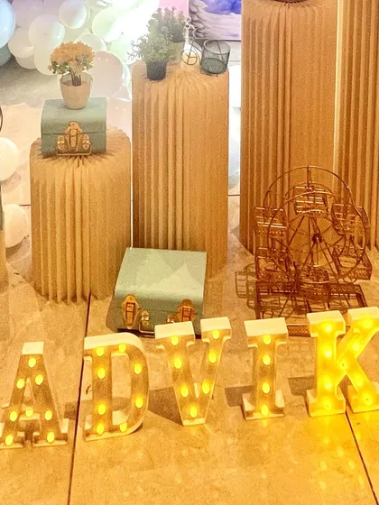 Personalized light-up marquee letters spelling out the birthday girl's name, "AADVIK," adding a warm glow and a custom touch to the party decor.