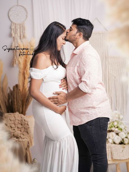 A tender moment between a couple in the boho studio. The white dress and neutral decor create a pure and serene atmosphere.