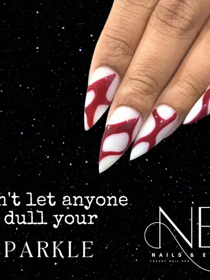 "Don't let anyone dull your sparkle." This sharp, stiletto nail design with a bold red and white pattern is designed to stand out.