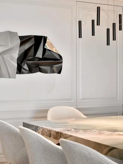 A detail shot highlighting the contrast between the matte grey and crumpled black sections of the sculpture.
