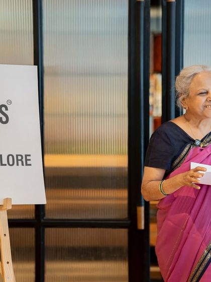 A mother shares her poetry with a radiant smile at our Mother's Day event. It was a beautiful morning celebrating the warmth and care of mothers.