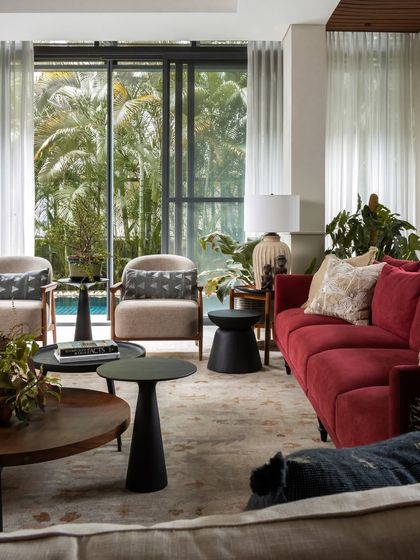 A full view of the living space, showcasing the layered seating arrangement, the connection to the outdoor pool area, and the balance of color and neutral tones.