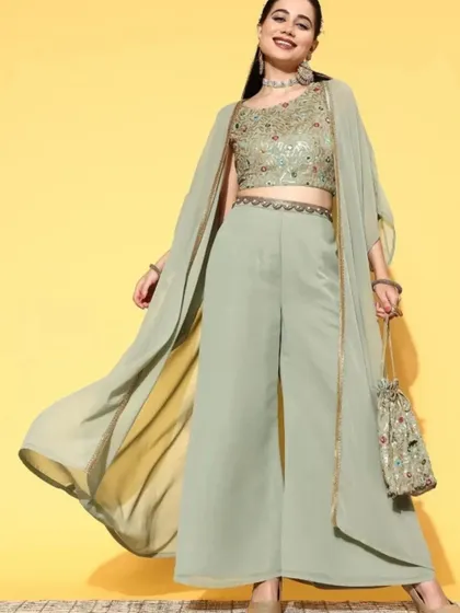 A modern and chic take on ethnic wear. This three-piece co-ord set includes a sequined crop top, comfortable palazzo pants, and a flowing georgette shrug. It's a stylish and easy-to-wear option for any celebration.