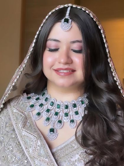 A close-up of Priyal's makeup. I used soft pink tones on her eyes and lips, paired with a flawless airbrush base, to create a look that is both romantic and modern.