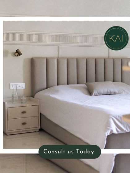 A close-up of a bedroom we designed, featuring a bed with a tall, channel-tufted headboard and matching nightstands. The wall-mounted reading lights add a functional and stylish touch.