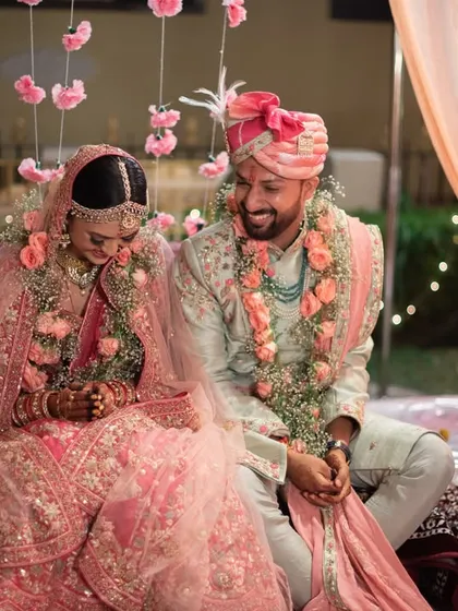 A candid moment of the couple sharing a laugh during their wedding ceremony.
