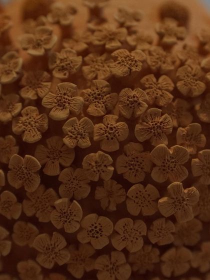 Here is the floral vase after its first firing, known as a bisque. The intricate details of the unglazed clay flowers are so beautiful on their own, it almost feels a shame to glaze it.