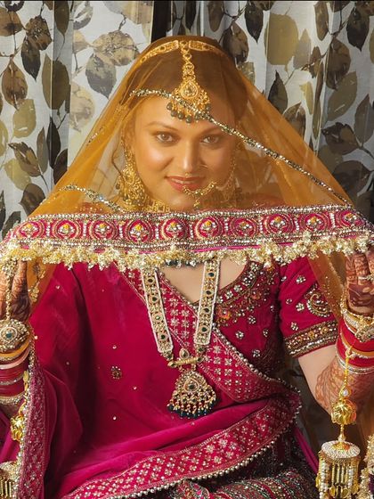 Another beautiful shot from under the veil, highlighting the intricate eye makeup and the overall radiance of the bridal look.