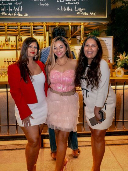 A group of friends poses by the bar, dressed up for a fabulous night out at Roxie.