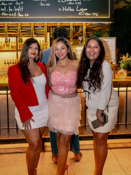 A group of friends poses by the bar, dressed up for a fabulous night out at Roxie.