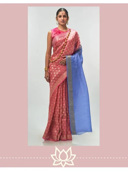 This opulent tissue jacquard saree in absolute coral features a contrasting blue pallu, creating a bold and beautiful statement. It is a modern interpretation of bridal wear, designed to be unforgettable.