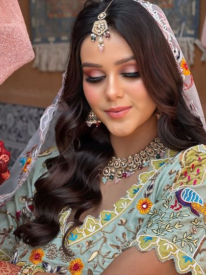 A serene and beautiful portrait. The makeup is soft and romantic, perfect for a daytime Mehendi event.