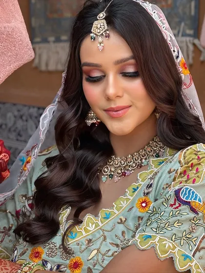 A perfect Haldi or Mehendi look. The soft pink and brown eye makeup complements the pastel outfit beautifully, creating a fresh and youthful vibe.