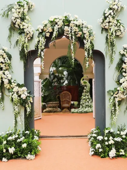A beautiful archway adorned with cascading white flowers creates a stunning entrance. I use floral design to frame spaces and create breathtaking first impressions for your guests.