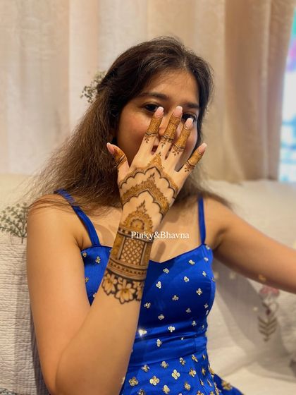 A close up of a simple and elegant back hand design. The architectural motif on the wristband combined with a clean palm makes for a very chic and modern statement.