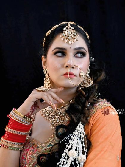 A thoughtful glance away. This angle highlights the flawless cheek contour and the way the matha patti beautifully frames the face.