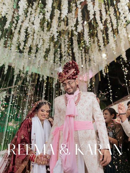The couple's grand exit after their wedding ceremony, showered with confetti. Their happy faces and linked hands mark the beginning of their journey as partners.