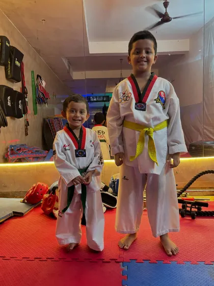 Two proud students standing tall in the academy. You can see the confidence in their stance. This is what we build here, one class at a time.