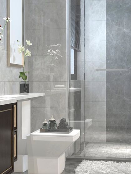 This view shows the complete bathroom setting, featuring a dark wood vanity that provides a rich contrast against the light grey wall and floor tiles. The design demonstrates how my custom furniture integrates perfectly within the overall interior design.