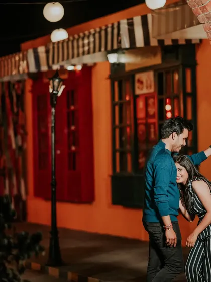 A quiet, romantic moment against a colorful, warmly lit street-style set. These setups allow for a variety of moods and styles, all in one location.