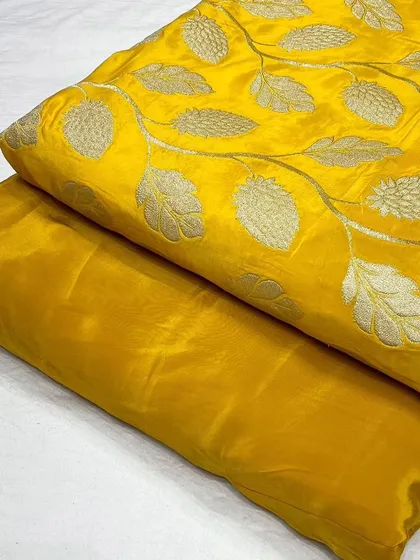 A bright yellow designer crepe jacquard fabric, ideal for festive wear.