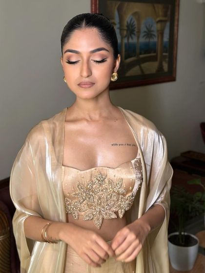 Eyes closed to showcase the warm, blended eyeshadow of the Latina glam look. The tones are chosen to create depth and a sultry, smoldering effect.