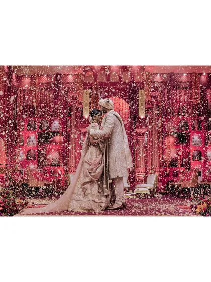 Tanya and Shivam are showered with petals after their varmala. This moment of celebration, with the couple at the center of a whirlwind of flowers and love, is a classic and beautiful wedding memory.