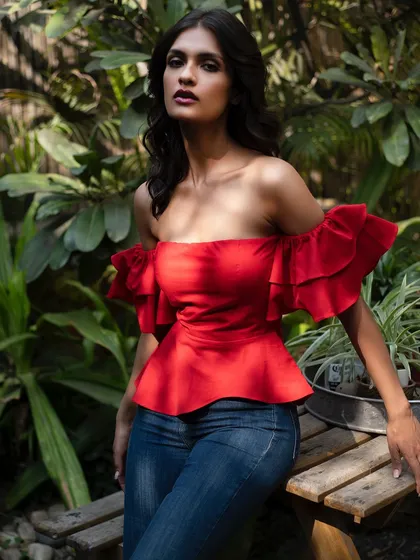 A vibrant red off-the-shoulder top from It Girl, perfect for a sunny day. The ruffles add a playful touch.