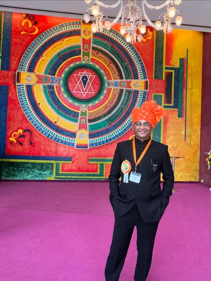 A full-length portrait taken at the award ceremony venue, showcasing the formal attire for the special occasion.