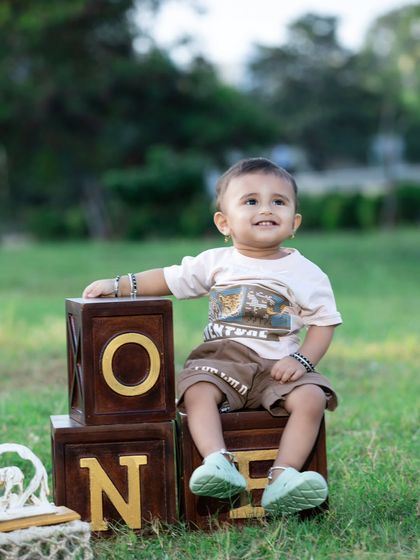 An outdoor first birthday shoot with classic wooden 'ONE' blocks. A simple and timeless way to celebrate.