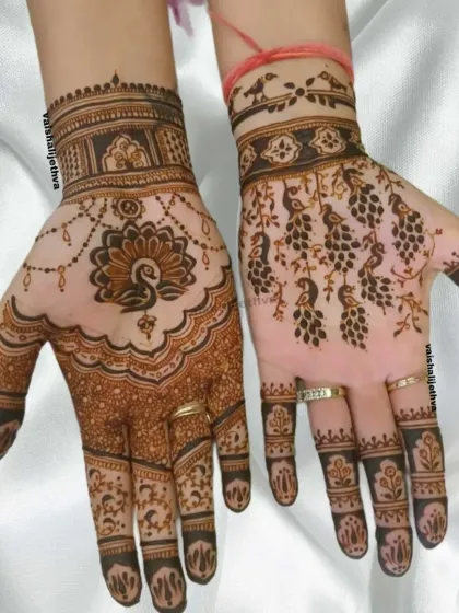 A trendy design featuring peacocks. One hand has a full peacock mandala, while the other has a lighter pattern of peacock feathers, creating a beautiful asymmetry.