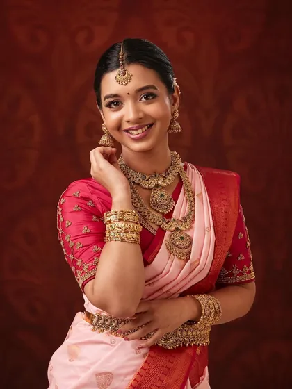 This professional photoshoot shows the fine details of my antique gold jewellery. The set includes a beautiful choker, a layered necklace, and matching bangles, perfect for achieving an authentic South Indian bridal look.