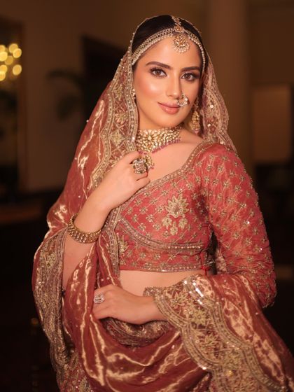 Heritage draped in elegance. This close-up shows the rich velvet dupatta and the traditional polki jewelry, a nod to royal Indian history.