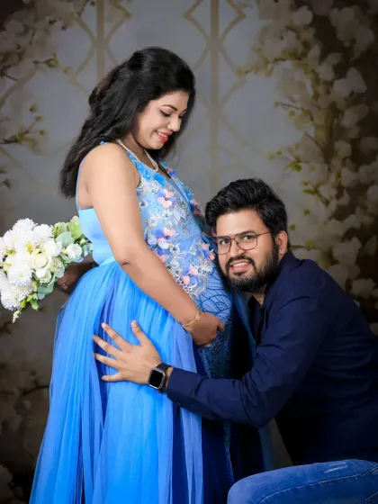 A classic and heartwarming pose where the dad-to-be listens to the baby bump. It’s a sweet way to show the connection the whole family already shares.