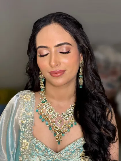 A soft and dreamy look for a morning Roka ceremony. The focus was on creating a flawless, natural-looking base with subtly defined eyes and a neutral lip color, letting her beautiful jewelry stand out.