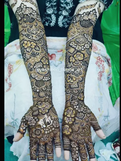 Alfiya's bridal mehndi, where her name is subtly woven into the intricate pattern on her palm.