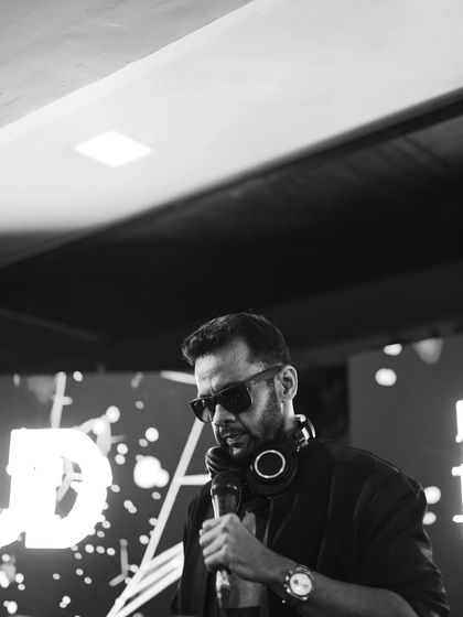 Another look from behind the console, holding the mic. I'm always ready to engage with the audience and hype up the crowd when the moment is right.