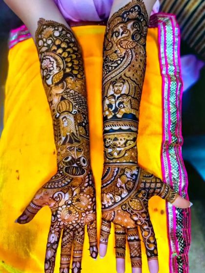 This full-arm design is a testament to intricate artistry, featuring portraits, peacocks, elephants, and a doli scene, all woven together in a seamless narrative.