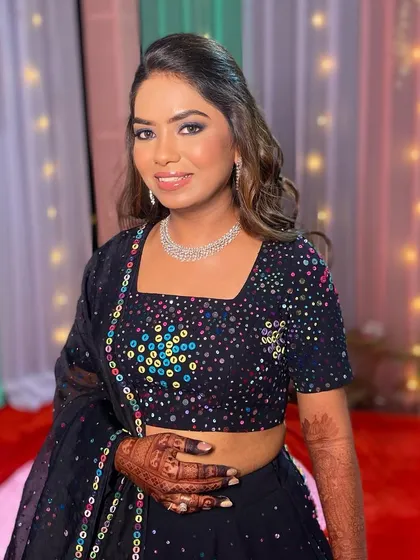 The bride looking confident and ready for the party. Her makeup is designed to make a statement and last all night.