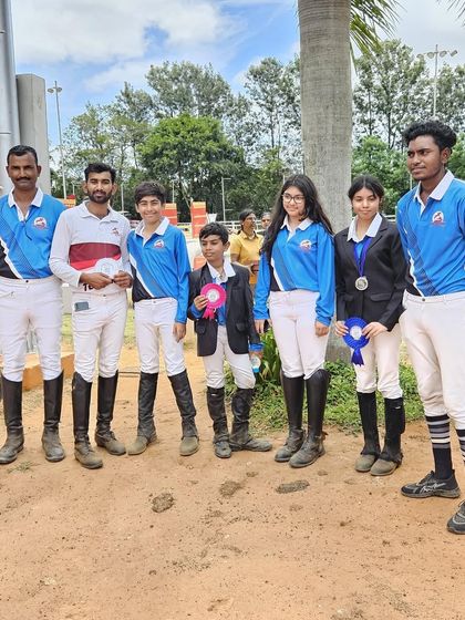 A group of our riders with their ribbons after a successful competition day. We are so proud of our debutantes and seasoned competitors alike for their 'Can Do' attitude.