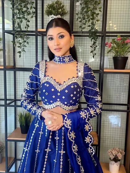 A perfectly curated look for a sangeet. The royal blue lehenga with mirror work is paired with dramatic blue smokey eyes.