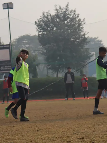 Players interacting on the field during a break in the HCL league match. Team bonding is a key part of our approach.