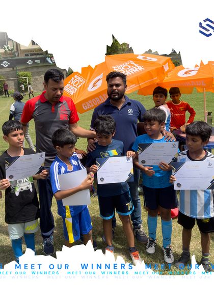 A group of our football program participants posing with their certificates after competing in our academy's event. Every player who participates gains valuable match experience and is a winner in our eyes.
