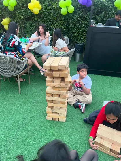 Happy moments at Hoppers, with kids and adults enjoying games like giant Jenga in our outdoor area.