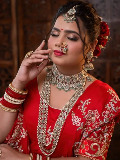 This image highlights the rich jewelry and deep red tones that are characteristic of a traditional Maharashtrian bride.