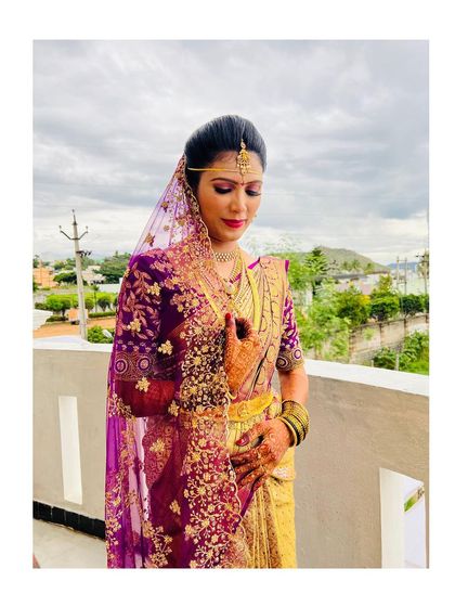 A quiet moment of reflection for the bride. The soft, matte makeup with a pop of color on the lips creates a look of timeless elegance.