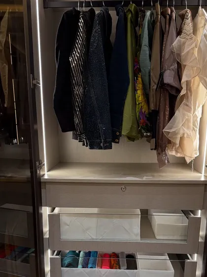 This section of a closet is perfect for evening wear and party outfits, with hanging space above and drawers for folded items below.