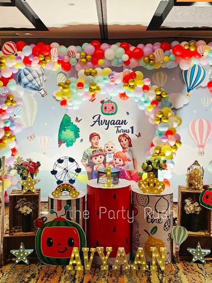 Cocomelon is a favorite, and I go all out to bring it to life. This vibrant setup for Avyaan's first birthday includes a massive balloon arch with hot air balloon details, character cutouts of the whole Cocomelon family, and themed props like the iconic yellow school bus.