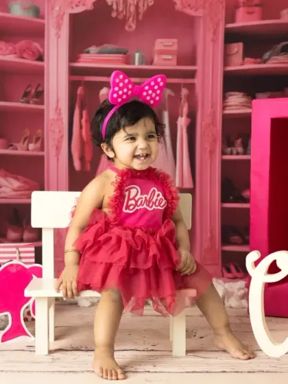 A little girl celebrating her first birthday, Barbie style. I provide the costume and props to make her milestone shoot extra special and vibrant.